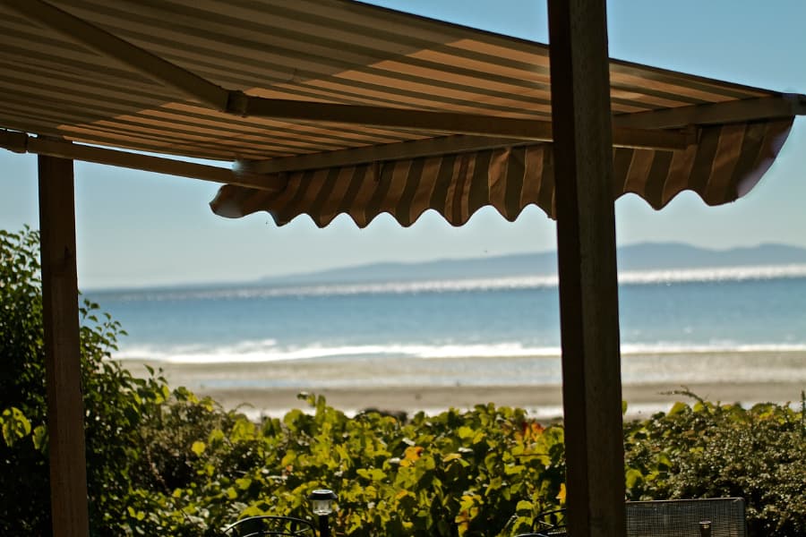 Retractable Awning Overlooking the Beach with Ocean Waves
