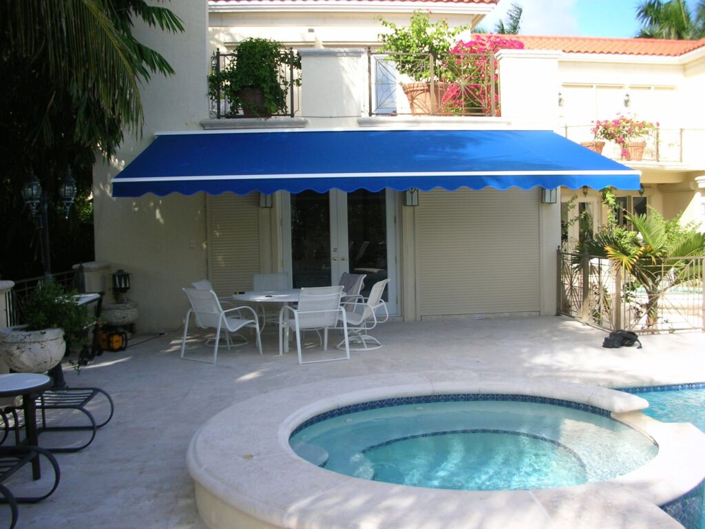 Blue Retractable awning on the back of a Florida house